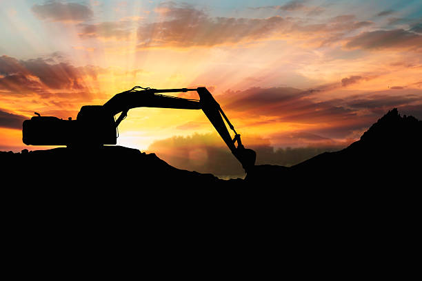 istock Crawler excavators silhouette are digging the soil 2247621140