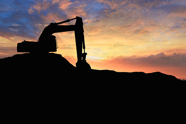 istock Crawler excavators silhouette are digging the soil . 2247621146