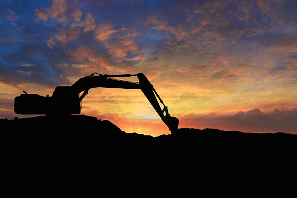 istock Crawler excavators silhouette are digging the soil . 2247621244