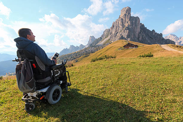 istock Disabled man in wheelchair enjoys Dolomites 2247623680