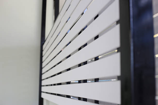 istock A modern white slat wall (or fence) installed on a dark metal frame 2247623788