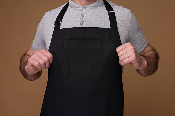 istock Man wearing kitchen apron on brown background, closeup. Mockup for design 2247625013