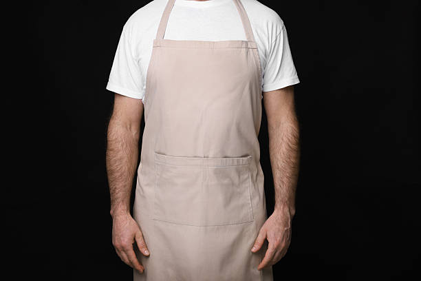 istock Man wearing kitchen apron on black background, closeup. Mockup for design 2247625033