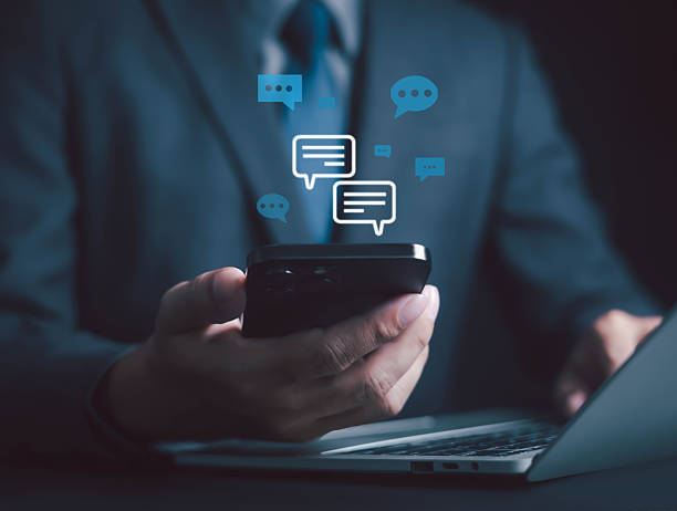 istock Businessman using smartphone with digital chat icons, symbolizing online communication, social media, messaging, mobile app, customer support for business networking, marketing, digital connection. 2247625108