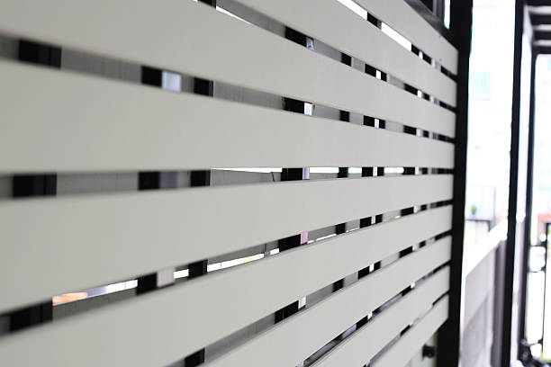 istock A modern white slat wall (or fence) installed on a dark metal frame 2247626871