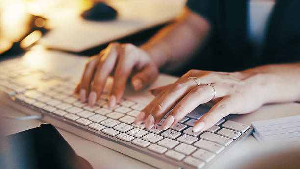 istock Hands, typing and person in home office with computer, night and research for remote work. Schedule, planning and freelance woman at keyboard writing article, email or online report with notes 2247627190