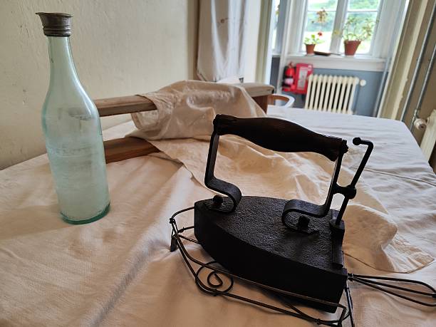 istock Vintage cast iron sad iron with wire stand 2247628431