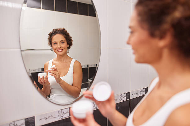 istock Woman applying moisturizer during her daily skincare routine 2247628955