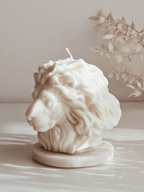 istock Elegant white lion-shaped candle Christmas decoration arranged on a table 2247630338