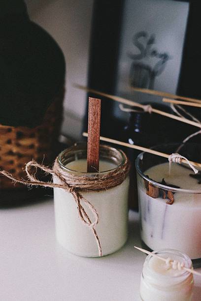 istock Scented home-made candles in a jar with cinnamon arranged on a table 2247630384