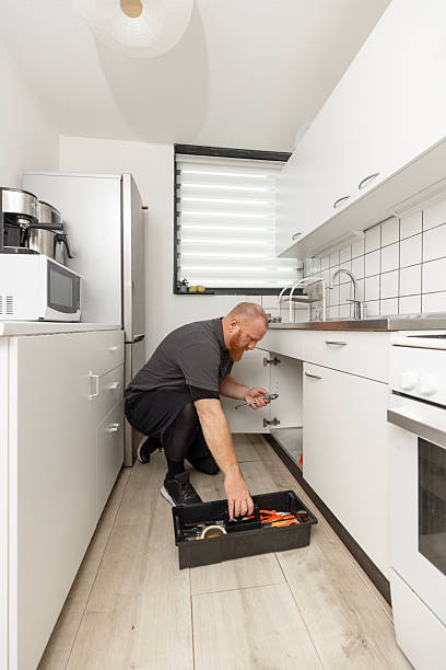 istock Redhead senior plumber working in a domestic kitchen 2247631162
