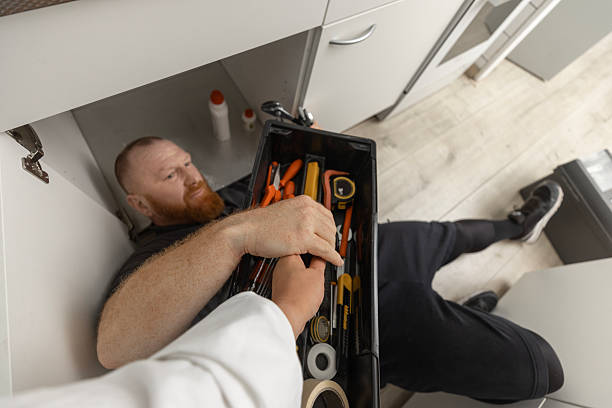 istock Redhead senior plumber working in a domestic kitchen 2247631444