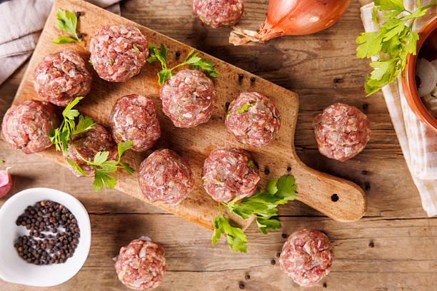 istock raw meatball with fresh ingredients 2247631765