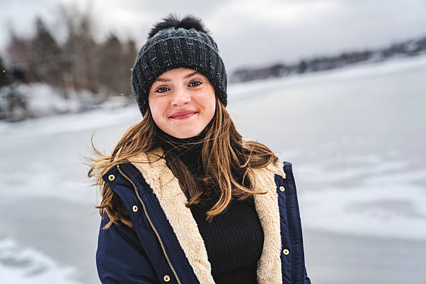 A cute Little girl in winter snow forest