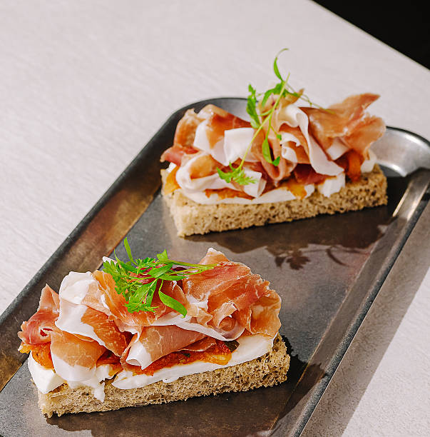 Delicious open-faced sandwiches with cured meat and fresh toppings