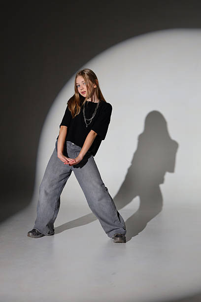 istock Young caucasian female posing against light circle in casual outfit 2247635678
