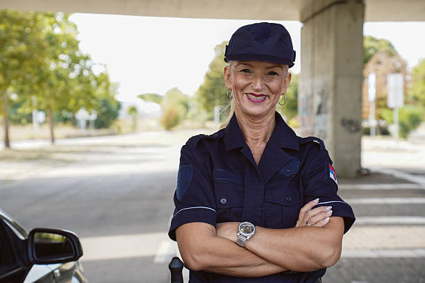 istock Female police officer using a radio while on duty 2247636146