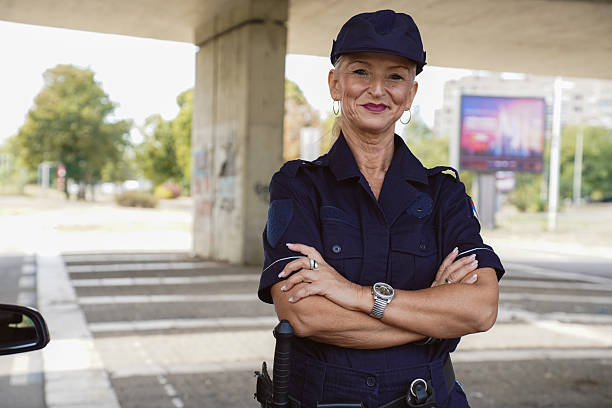 istock Female police officer using a radio while on duty 2247636147