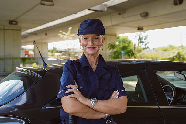 istock Female police officer using a radio while on duty 2247636180