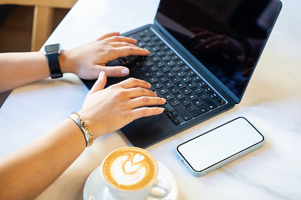 istock Close-Up of Hands Typing on Laptop with Coffee 2247636181