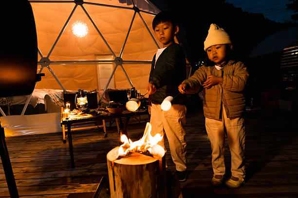 Children roasting marshmallows with a Swedish torch