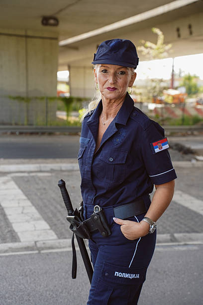 istock Female police officer using a radio while on duty 2247636208