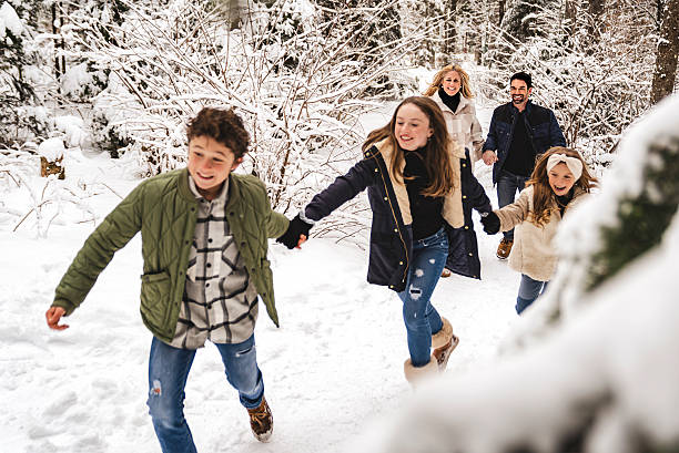 istock nice Family Having Fun running in winter season 2247638268