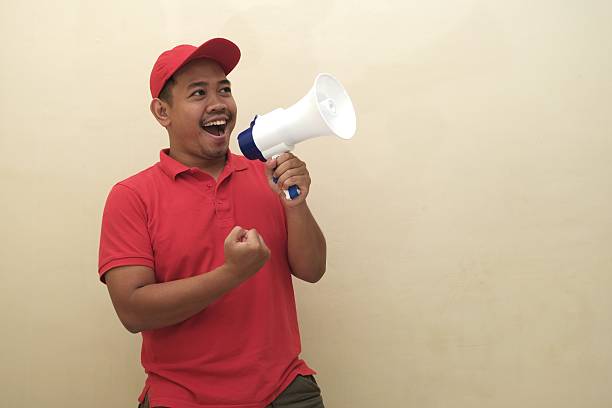 Southeast Asian man shouting into megaphone isolated for ad