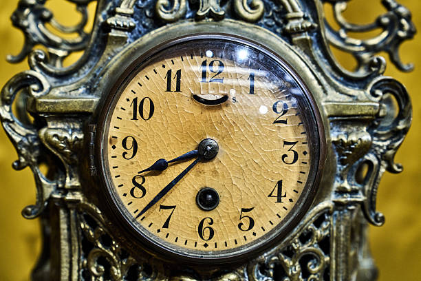 Antique clock stand on a wooden table