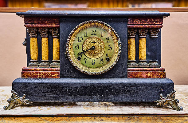 Antique clock stand on a wooden table