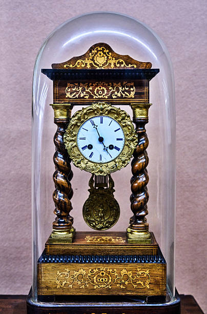 Antique clock stand on a wooden table