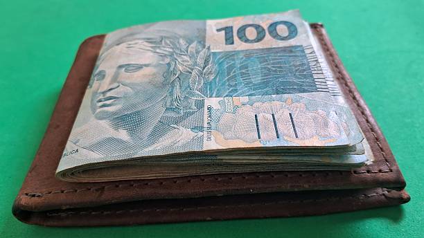 istock One hundred real notes on top of a leather walle 2247641601