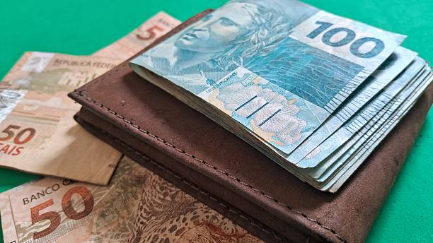 istock One hundred real notes on top of a leather walle 2247641709