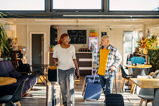 istock Multiracial couple leaving cafe after waiting for transportation and going on vacation with suitcases 2247643628