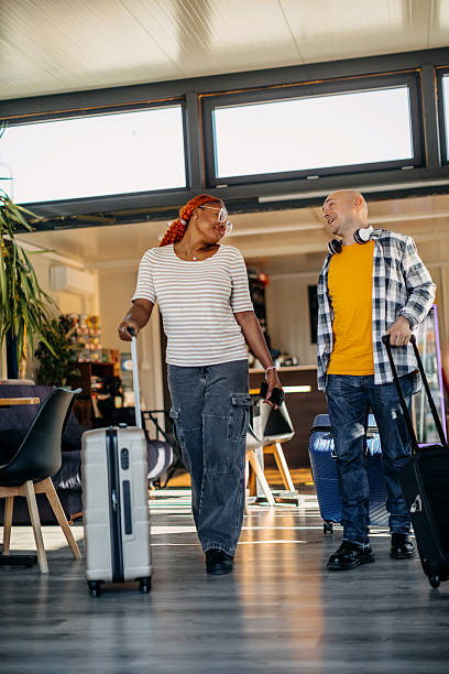 istock Multiracial couple leaving cafe after waiting for transportation and going on vacation with suitcases 2247643646