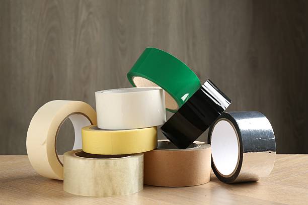 istock Rolls of different adhesive tapes on wooden table 2247647109