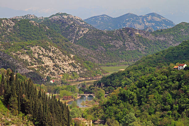 Rijeka Crnojevica, Montenegro - April 20, 2011: Aerial View of Village Spring Day Rural Nature Hills Mountains Woods Landscape.