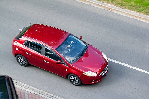 Ostrava, Czech Republic - May 9, 2025: Red Fiat Bravo Type 198 hatchback car  driving, motion blur effect