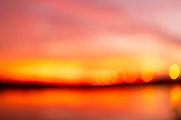 Orange blurred focus sky background,abstract pink orange blurred background with dark stripe on horizon. Blur pastel colored sweet dreamy background. Pink orange bokeh out of focus natural sky sunset background
