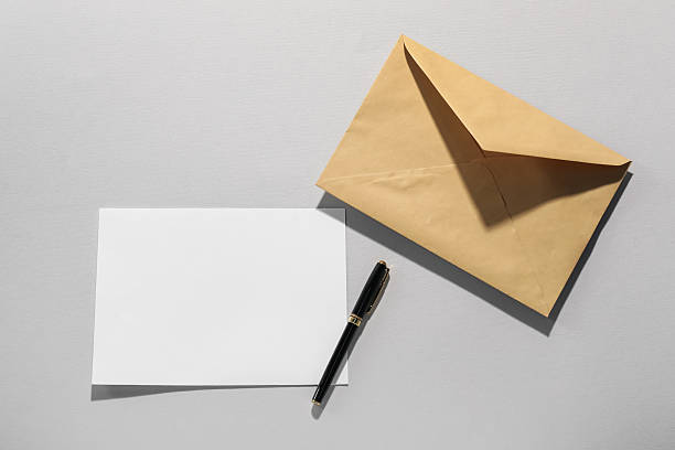 istock Kraft paper envelope, letter and pen on grey background, flat lay. Mockup for design 2247649100