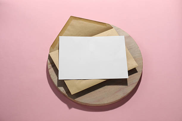 istock Kraft paper envelope with letter on pink background, above view. Mockup for design 2247649104