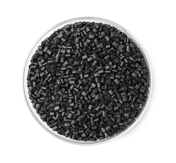 istock Black plastic granules in petri dish isolated on white, top view 2247649922