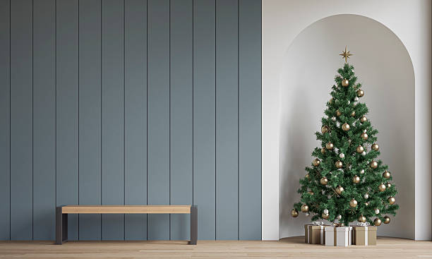 istock Modern minimalist interior decorated for Christmas, with a modern bench in front of light gray wooden slat / shiplap wall, a Christmas tree with presents in a wall niche, near a window 2247650115