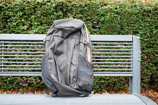 Black backpack on metal bench