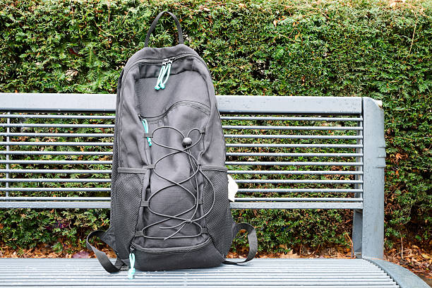 Black backpack on metal bench
