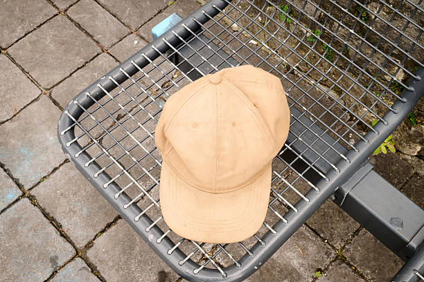 istock Outdoor. Baseball cap on a metal bench 2247651616