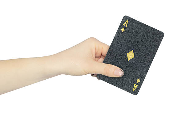 istock playing card diamonds ace in hand, outstretched hand with black playing card isolated from background 2247653459