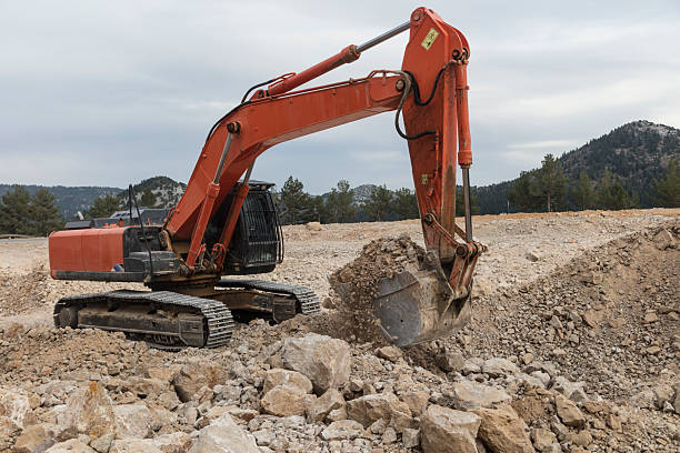Excavator digging into the ground with its large bucket