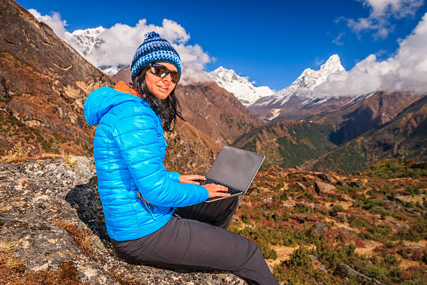 istock Young woman using laptop in Himalayas, Nepal 2247655793