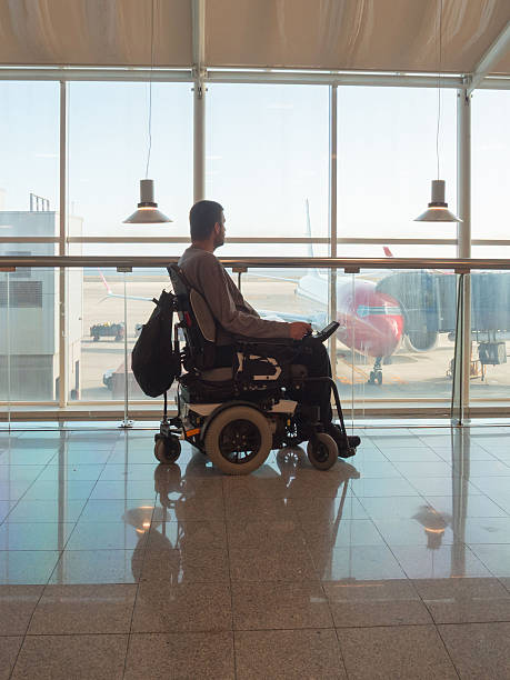 istock Person with disability using wheelchair at airport 2247655824